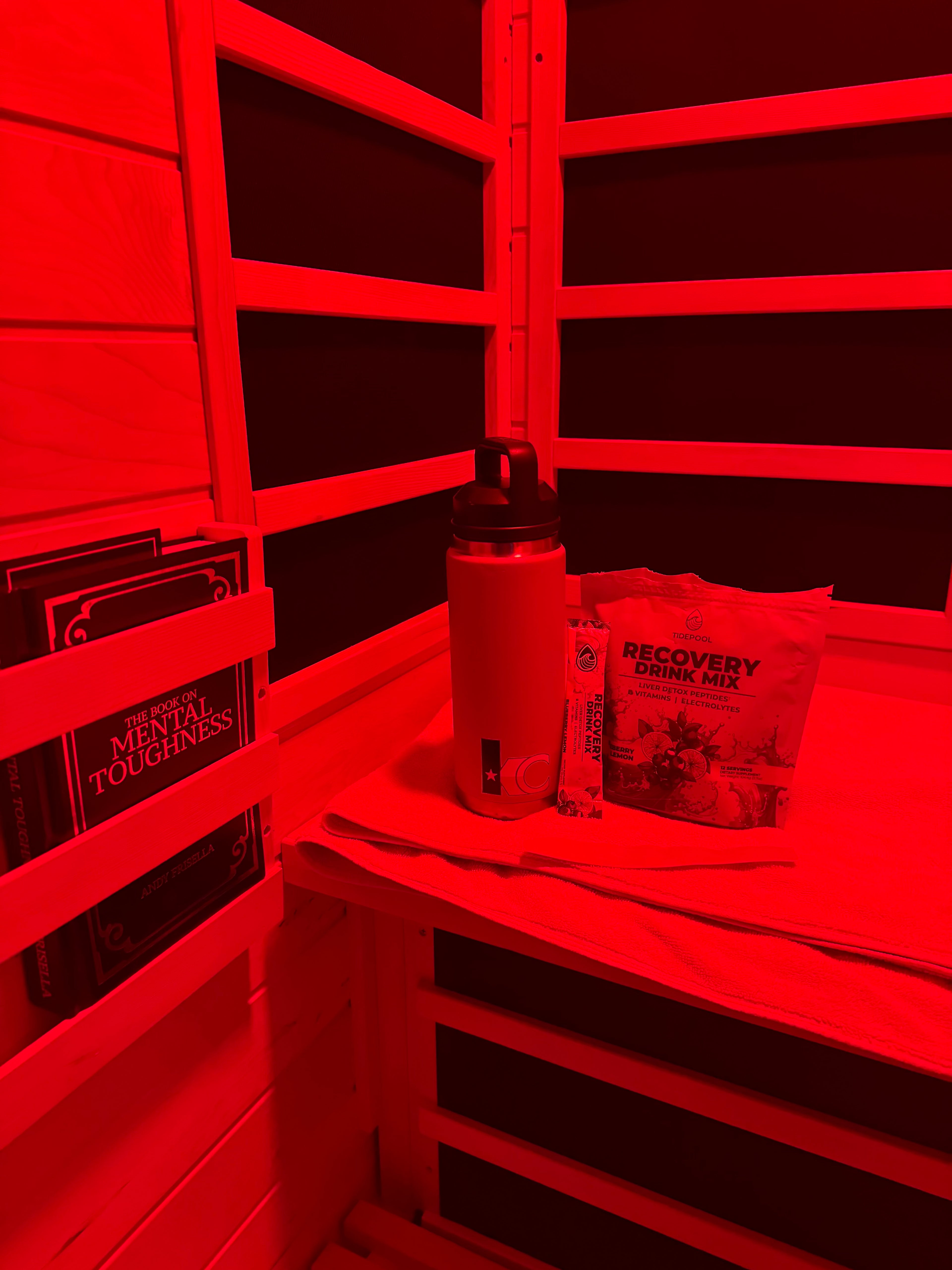 Red filter applied to a photo of a bed with a pillow and blanket.